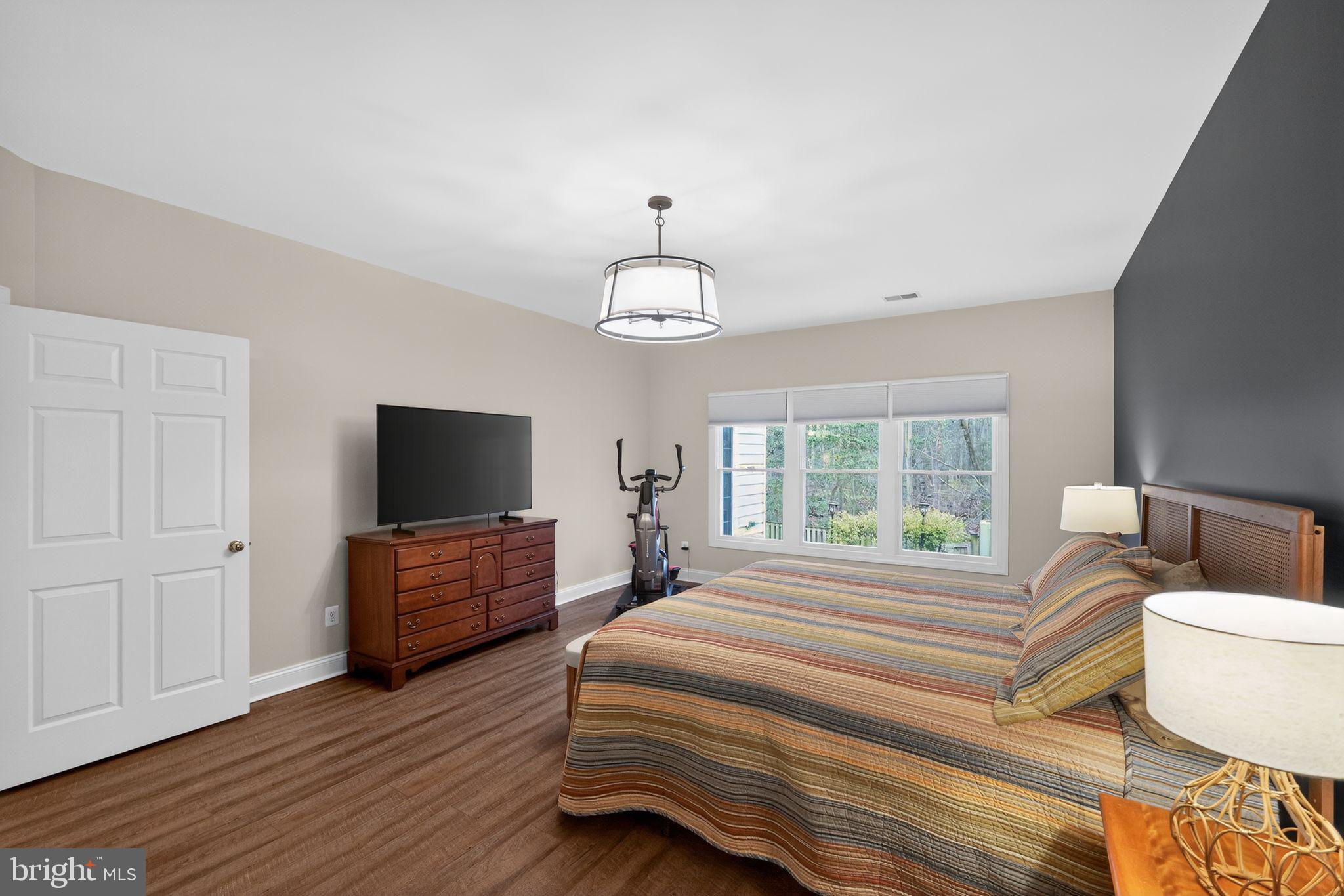 330 Colony Point Place Edgewater, MD 21037 - Photo 45 of 57 a spacious bedroom with a bed and a flat screen tv