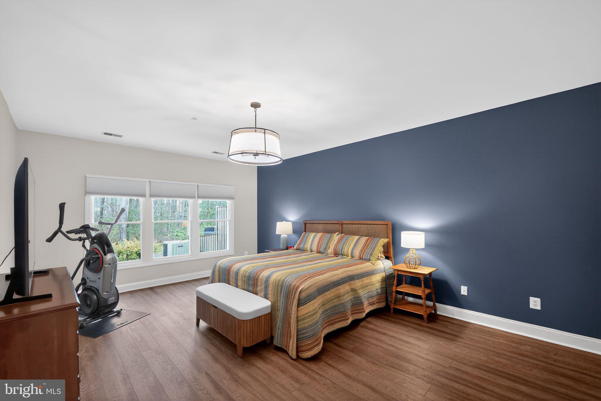 330 Colony Point Place Edgewater, MD 21037 - Photo 47 of 57 a bedroom with a bed and a chandelier