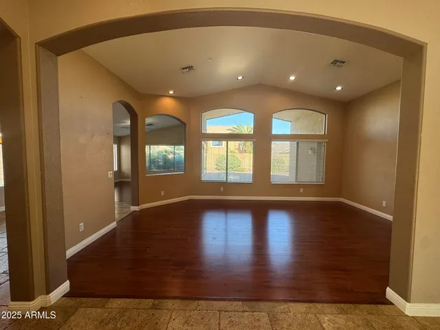 a large kitchen with granite countertop a stove a sink and a refrigerator
