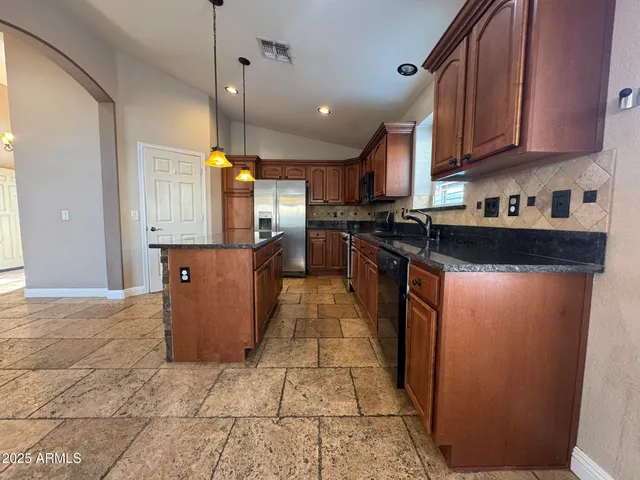 a view of a hallway with wooden cabinet and a hallway