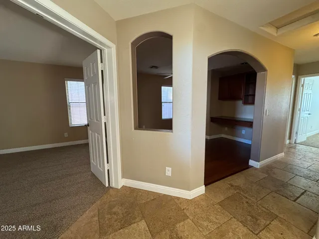 a view of a room with a ceiling fan and a window
