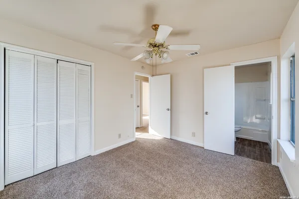 a view of a chandelier fan and closet area