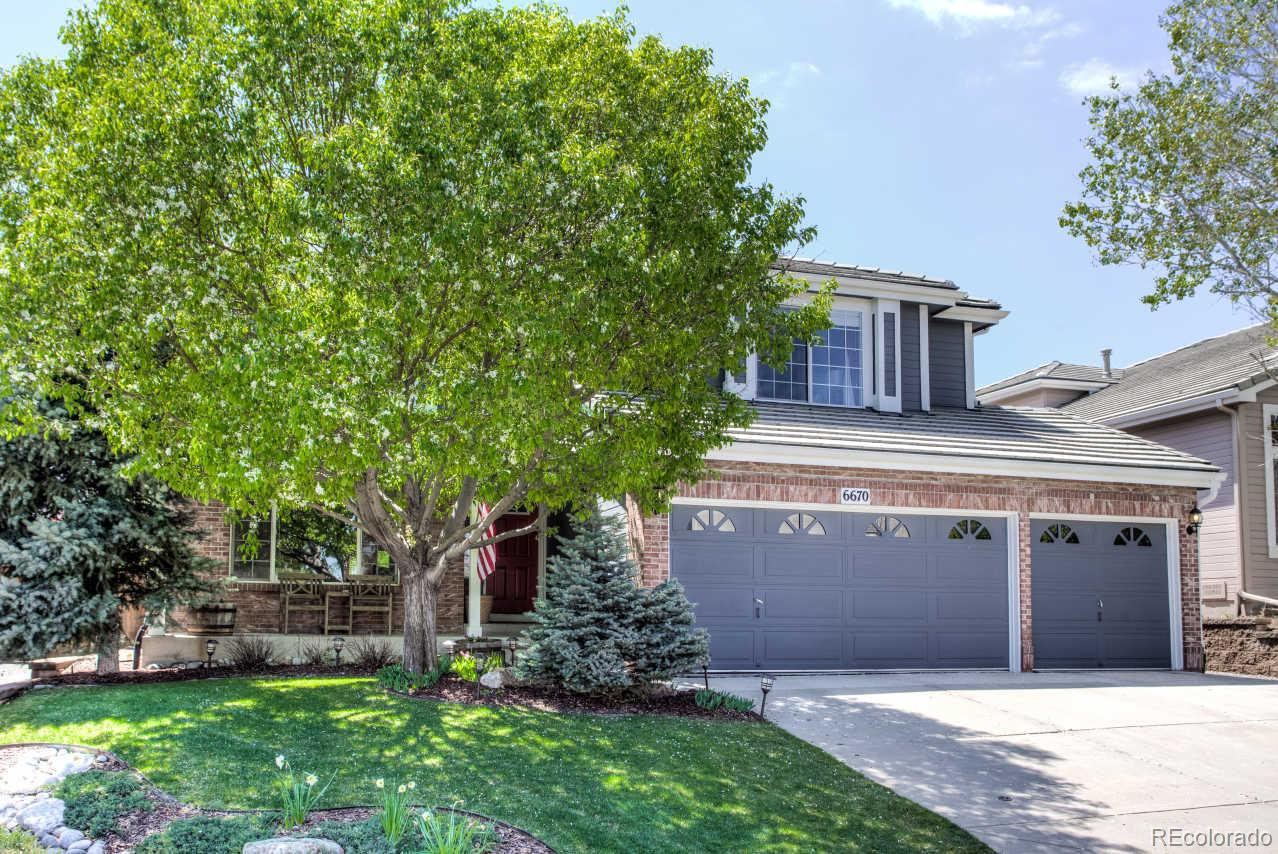 6670 Shannon Trail Highlands Ranch, CO 80130 - Photo 1 of 1 front view of a house with a garden