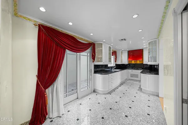 a kitchen with stainless steel appliances a sink a stove a microwave and cabinets
