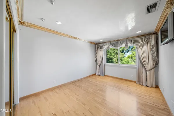 a bedroom with a bed and a couch
