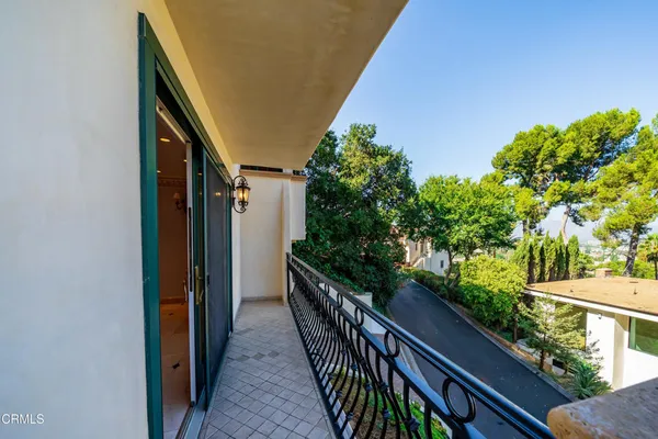 a view of balcony with wooden floor and fence