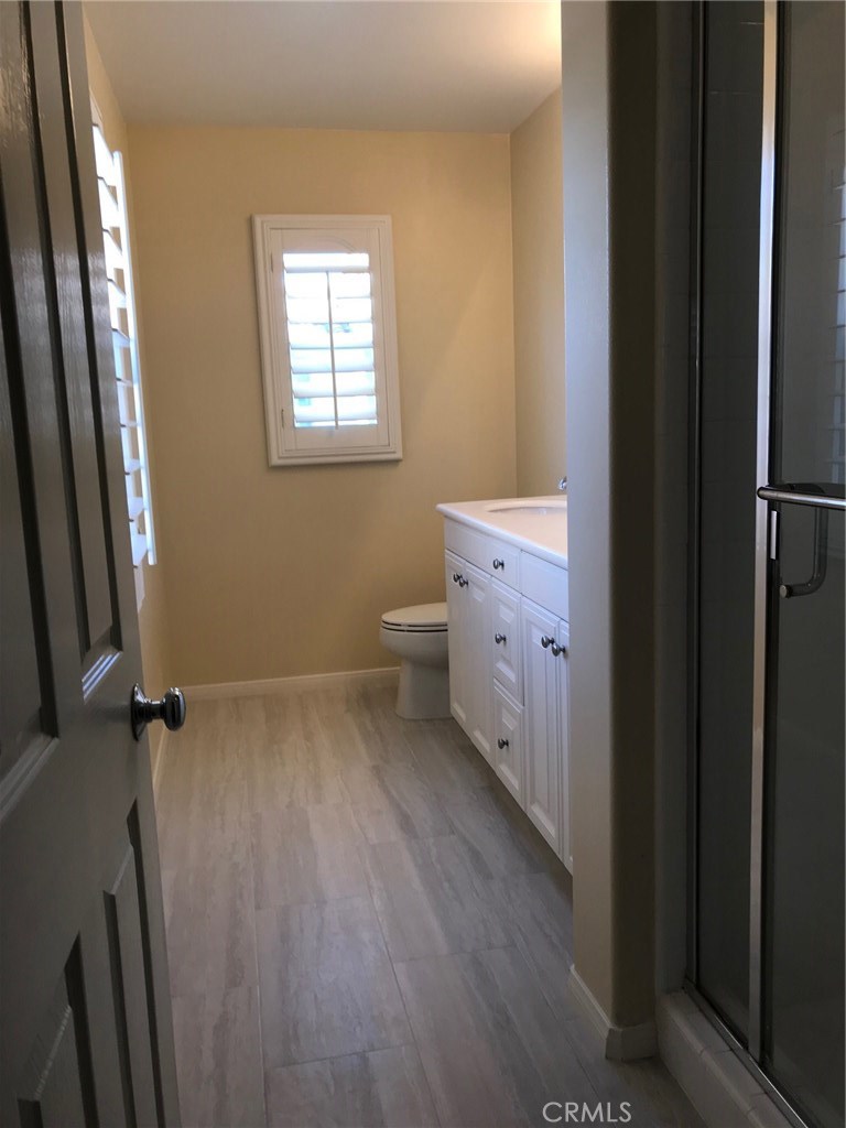 122 Reunion Irvine, CA 92603 - Photo 8 of 13 a bathroom with a sink a toilet and a mirror