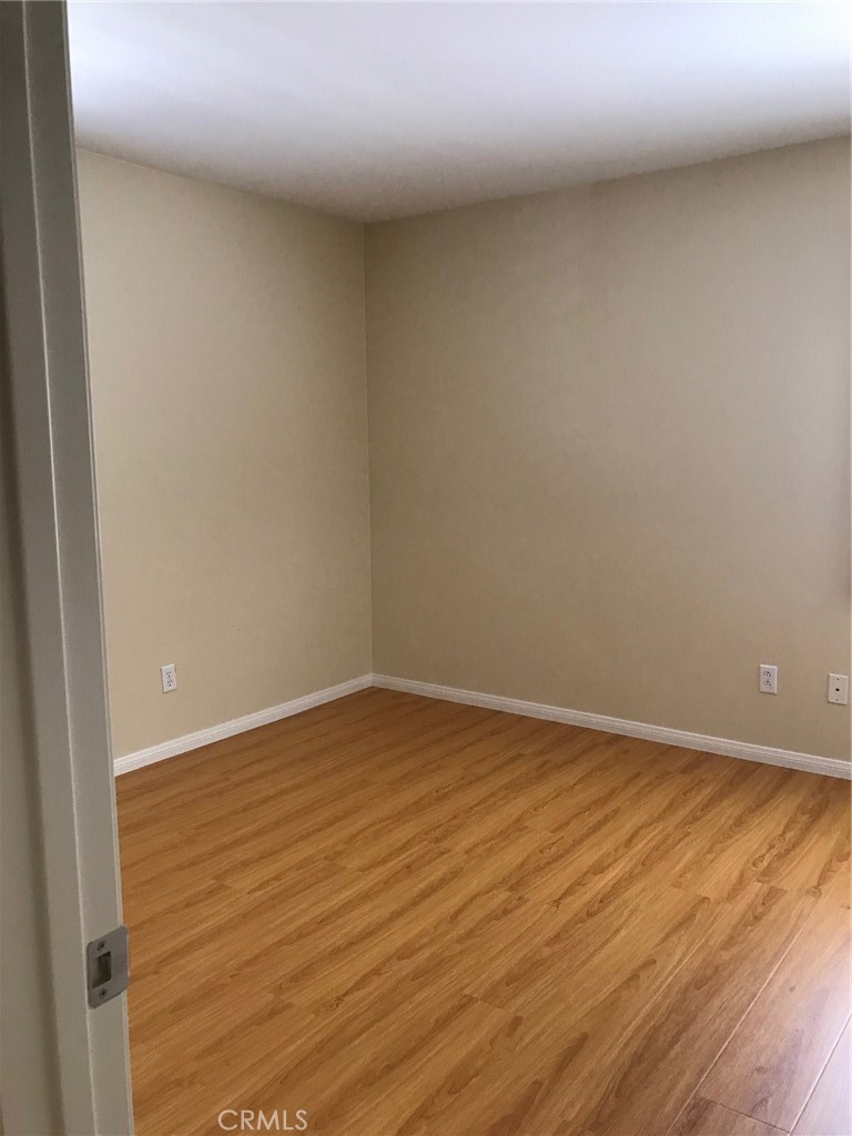 122 Reunion Irvine, CA 92603 - Photo 9 of 13 a view of an empty room with wooden floor
