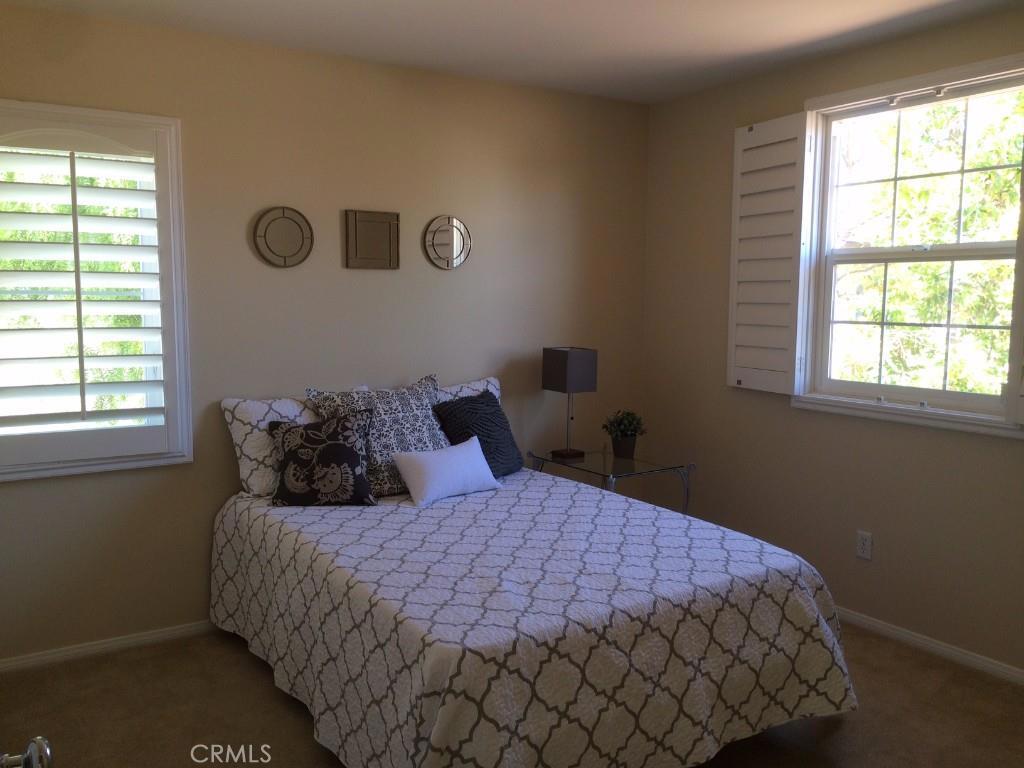 122 Reunion Irvine, CA 92603 - Photo 10 of 13 a bedroom with a bed and a window