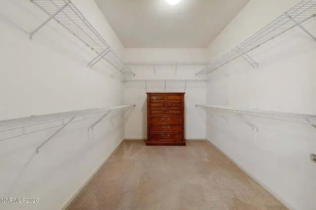 a view of room with wooden floor and fan