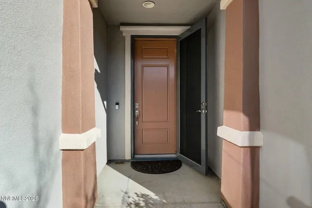 a living room with stainless steel appliances furniture and a wooden floor