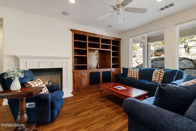 a view of a dining room with furniture a chandelier and wooden floor