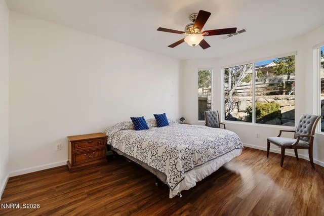 a bedroom with a large bed and a dresser
