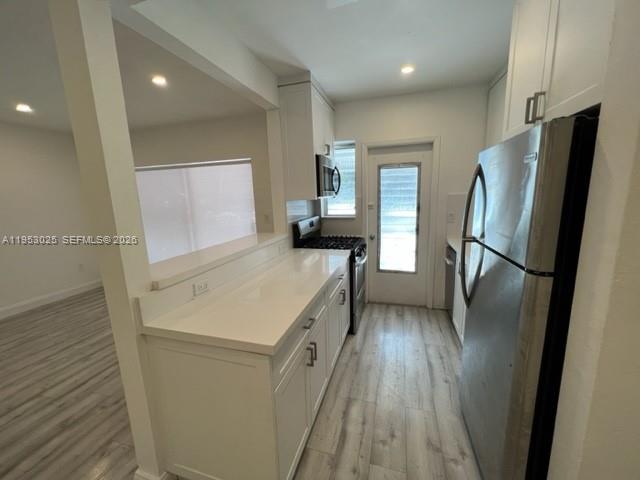 835 Meridian Avenue, Unit 1 Miami Beach, FL 33139 - Photo 2 of 3 a kitchen with a refrigerator a sink and dishwasher