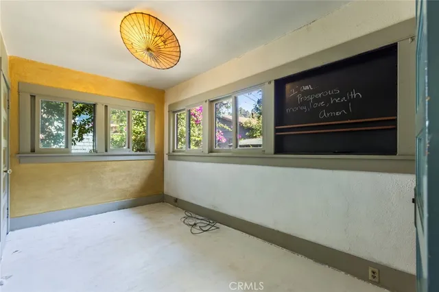 a view of room with window and wooden floor
