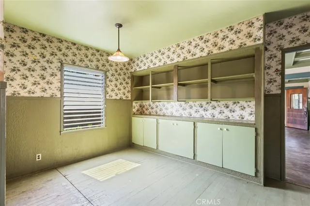a kitchen with granite countertop cabinets a sink and a window
