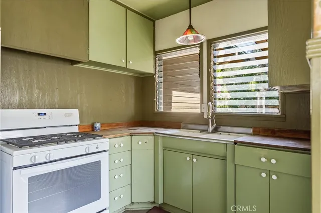 a kitchen with a sink cabinets and window