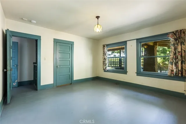 an empty room with windows and entrance