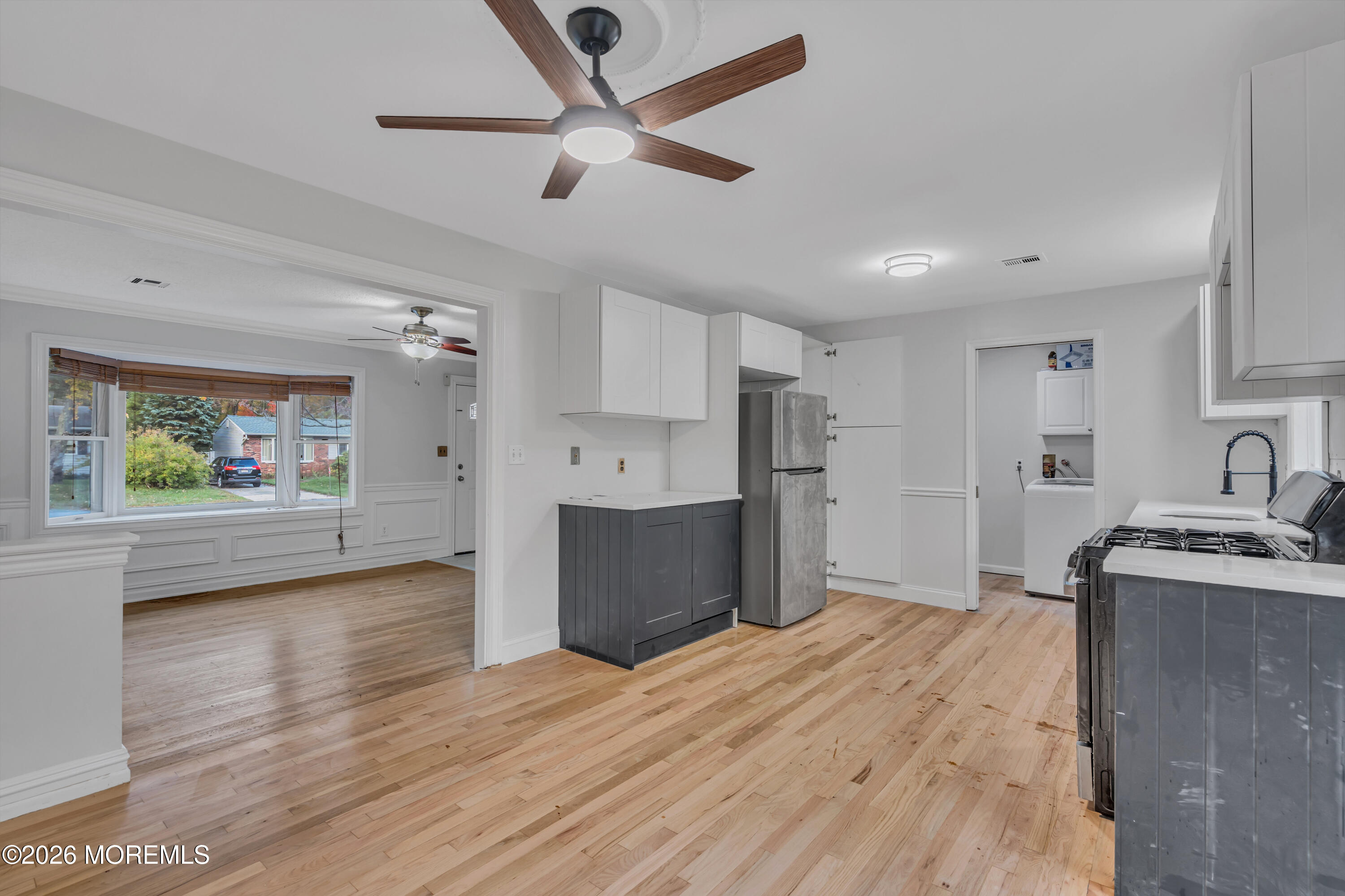 20 Jeanette Street Bayville, NJ 08721 - Photo 11 of 28 a kitchen with stainless steel appliances granite countertop a refrigerator a stove and a wooden floors