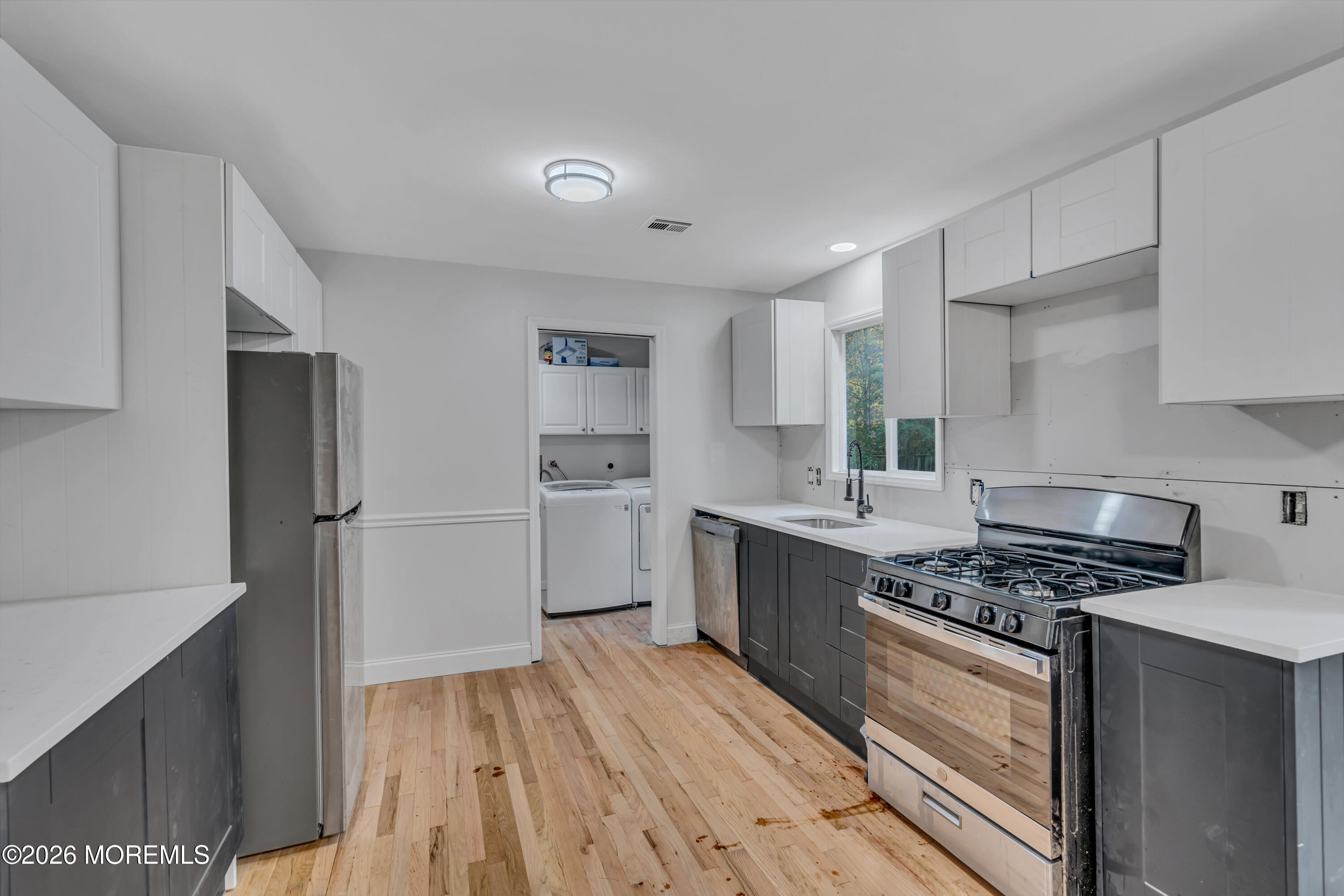 20 Jeanette Street Bayville, NJ 08721 - Photo 13 of 28 a kitchen with white cabinets and appliances