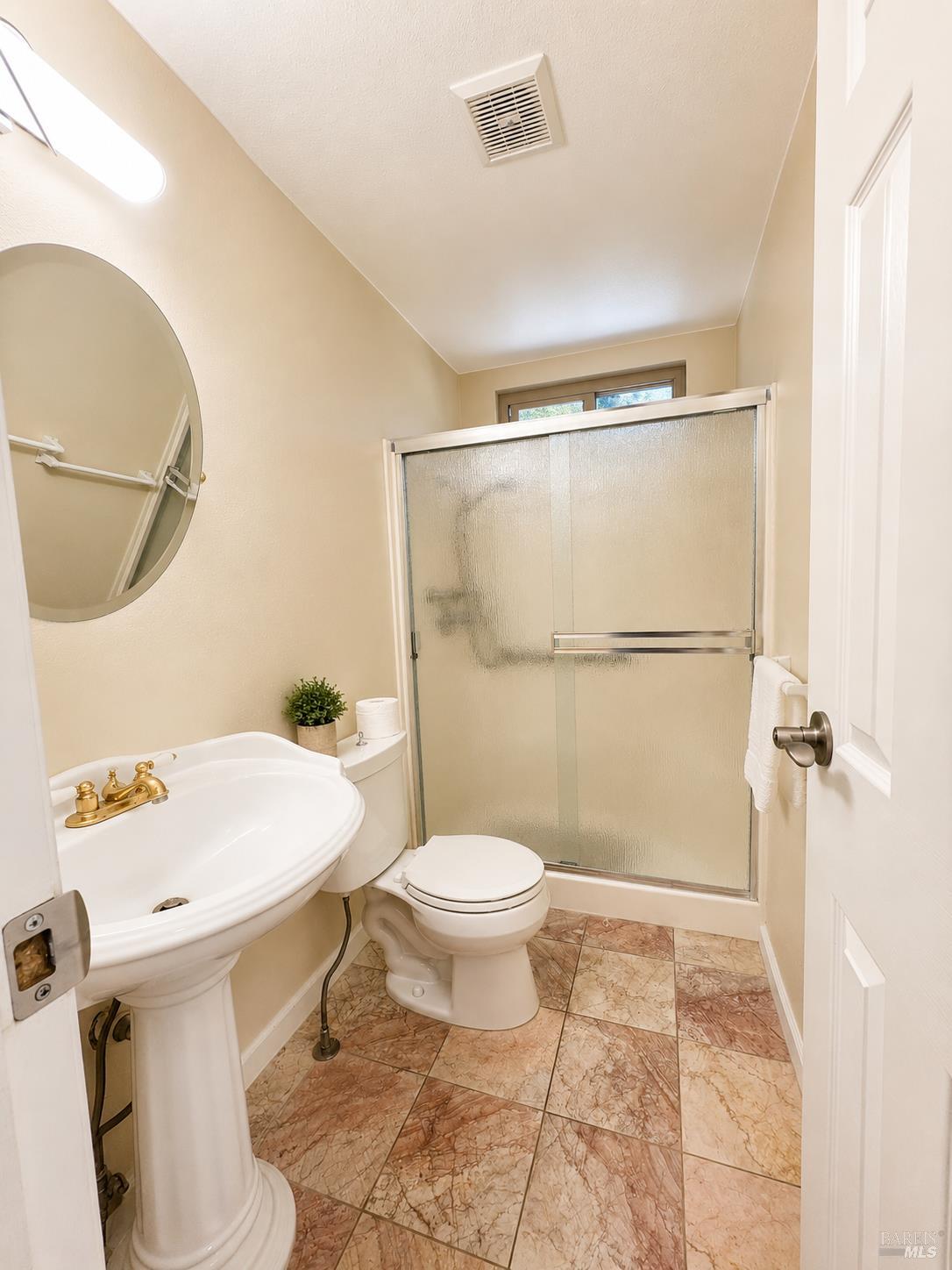 1945 Piner Road, Unit 16 Santa Rosa, CA 95403 - Photo 15 of 18 a bathroom with a sink toilet and shower