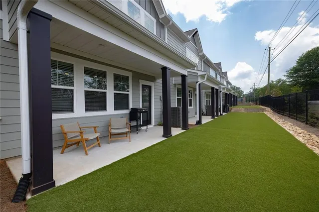 a view of a house with backyard porch and sitting area