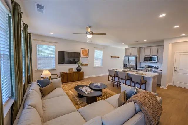 a living room with furniture and wooden floor