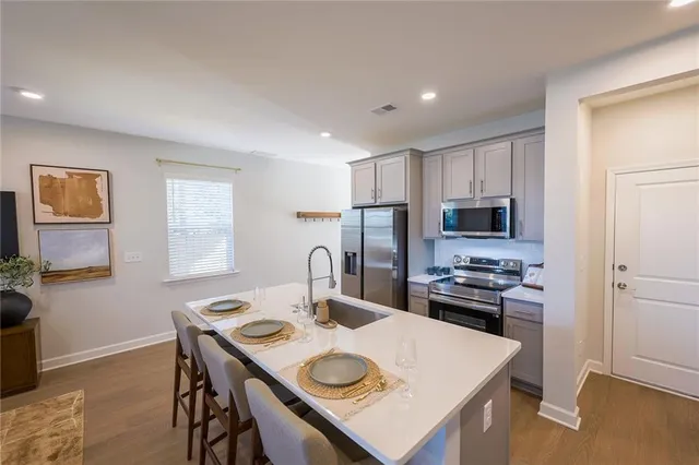 a living room with furniture a flat screen tv and a window
