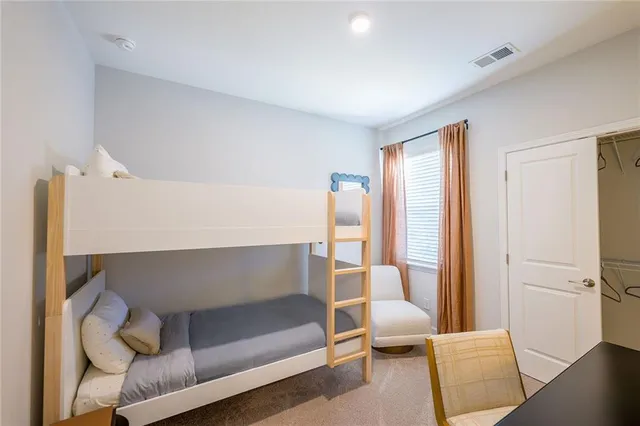 a bedroom with a bed and a night stand