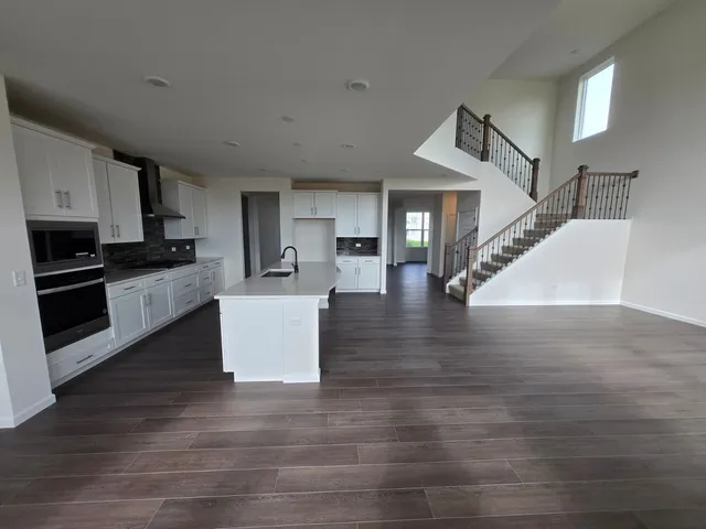 a view of kitchen with cabinets and wooden floor