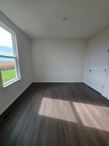 a view of wooden floor and windows in a room