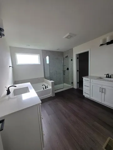 a living room with hard wood floors and a fireplace