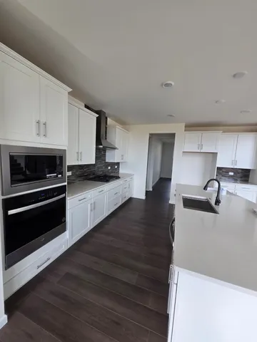 a kitchen with granite countertop a stove and a sink