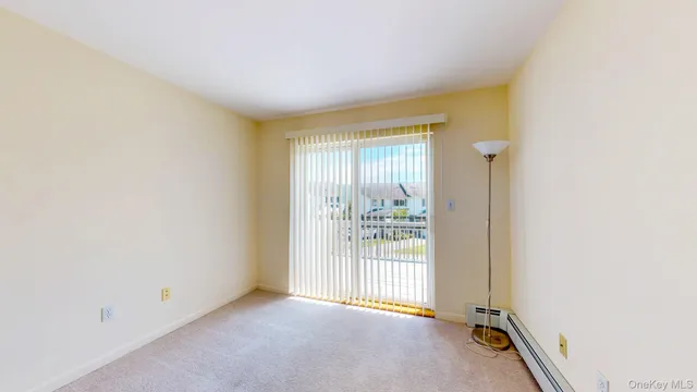 a view of a hallway with wooden floor and entryway