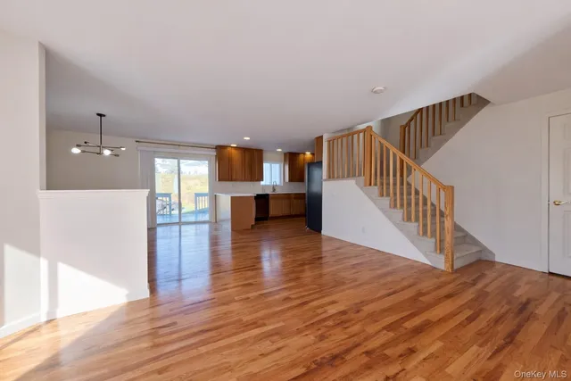 a kitchen with a refrigerator and wooden floor
