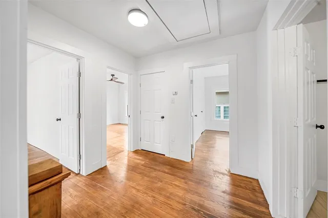 a view of walk in closet with wooden floor