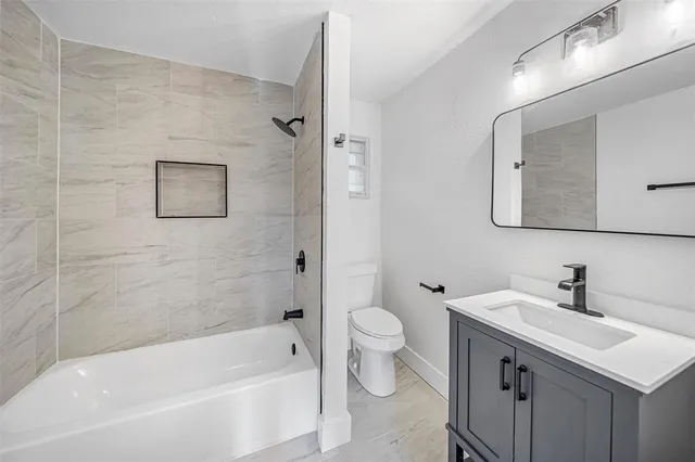 a bathroom with a sink mirror toilet and bathtub