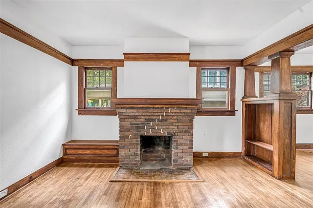 a living room with a fireplace and a wooden floor