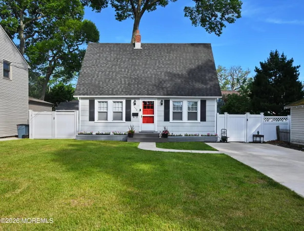 a front view of a house with a garden and yard