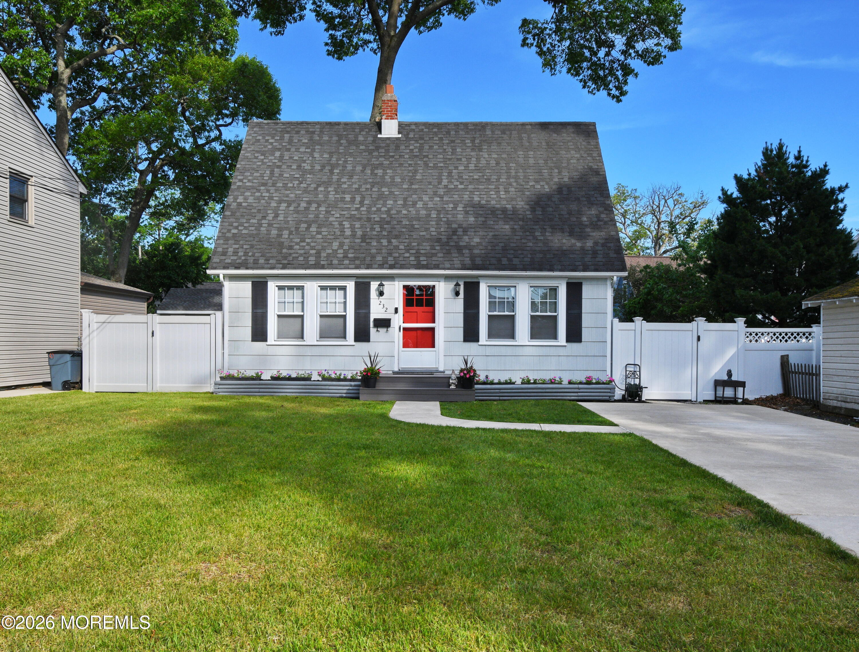 232 Pearce Avenue Point Pleasant, NJ 08742 - Photo 1 of 27 a front view of a house with a garden and yard