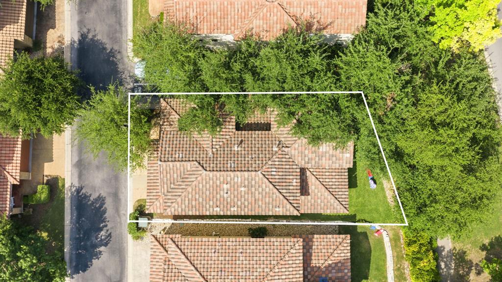 15317 Falconhead Grove Loop Austin, TX 78738 - Photo 28 of 29 An aerial perspective reveals a private residence nestled amidst lush, mature trees, offering tranquil seclusion.