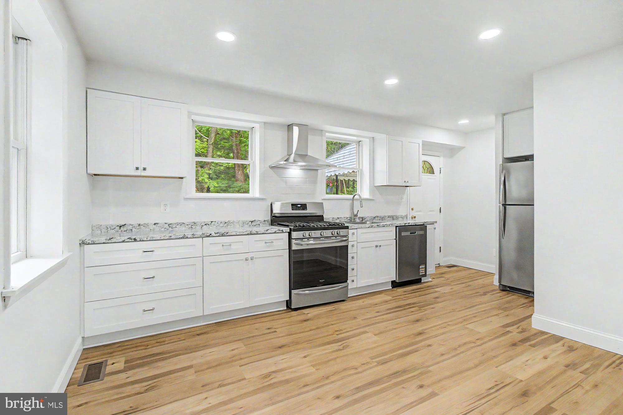 604 Prospect Mill Road Bel Air, MD 21015 - Photo 10 of 36 a kitchen with granite countertop white cabinets and white appliances