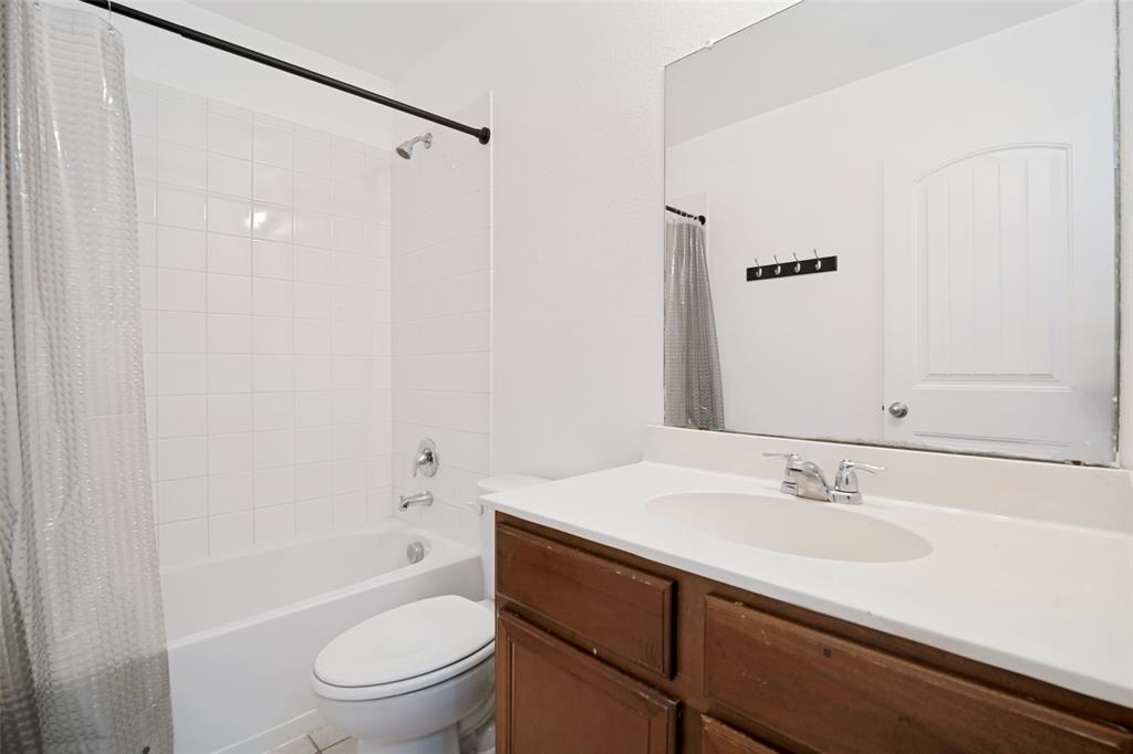 3415 Emerson Road Forney, TX 75126 - Photo 17 of 26 a bathroom with a sink a toilet and shower