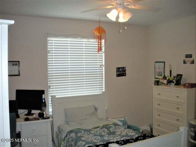 46 Molasses Court Fruit Cove, FL 32259 - Photo 12 of 17 a bedroom with a bed and a flat tv screen on dresser