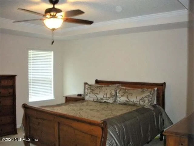 a bedroom with a bed and a chandelier