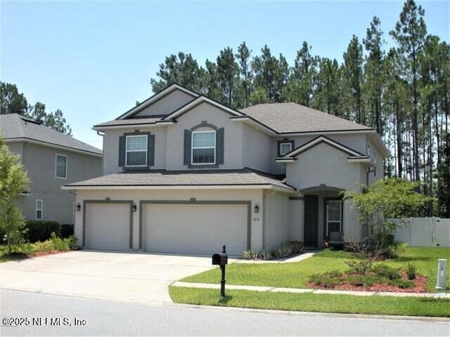 46 Molasses Court Fruit Cove, FL 32259 - Photo 2 of 17 a front view of a house with a yard and garage