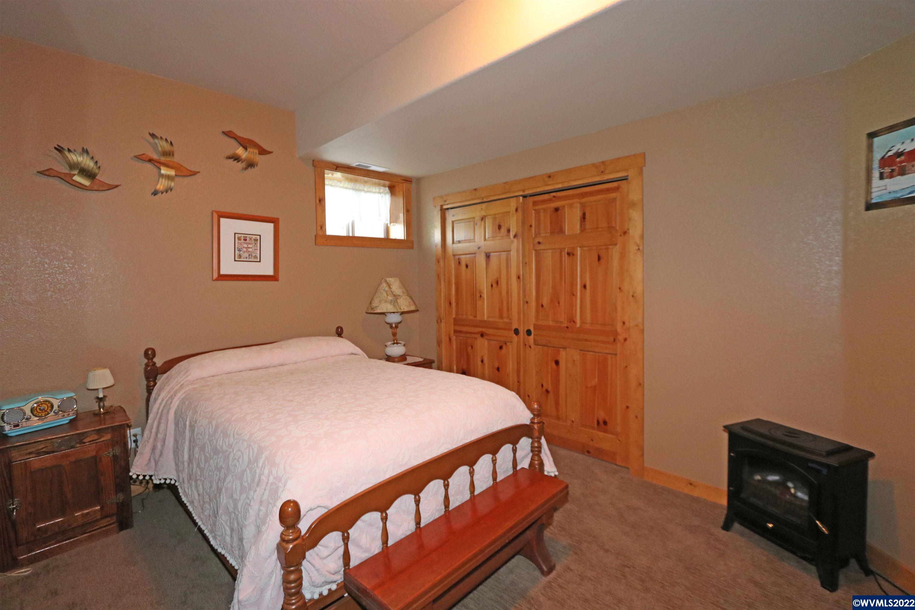 16955 Selden Road Dallas, OR 97338 - Photo 25 of 41 a bedroom with a bed and a tv