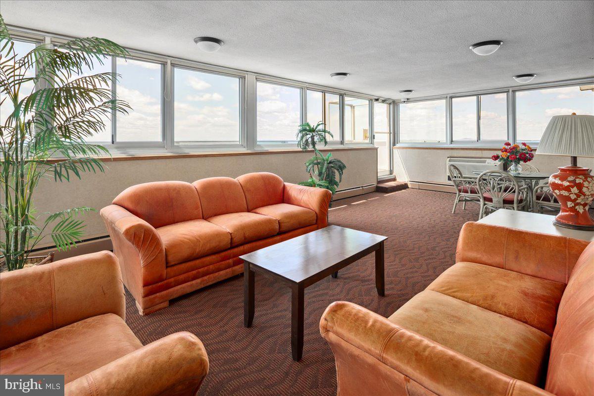 9701 Fields Road, Unit 1408 Gaithersburg, MD 20878 - Photo 25 of 29 a living room with furniture a fireplace and a large window