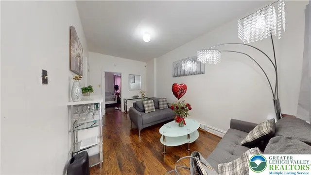 a living room with furniture and wooden floor