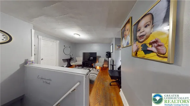 a kitchen with a refrigerator a stove top oven a clock and a window